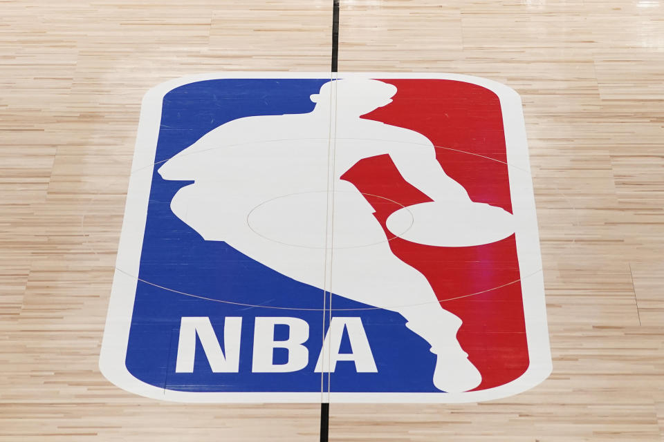 FILE - The NBA logo in shown on a basketball court in Lake Buena Vista, Fla., Friday, Aug. 28, 2020. Jerry West, who was selected to the Basketball Hall of Fame three times in a legendary career as a player and executive and whose silhouette is considered to be the basis of the NBA logo, died Wednesday morning, June 12, 2024, the Los Angeles Clippers announced. He was 86.(AP Photo/Ashley Landis, Pool, File)