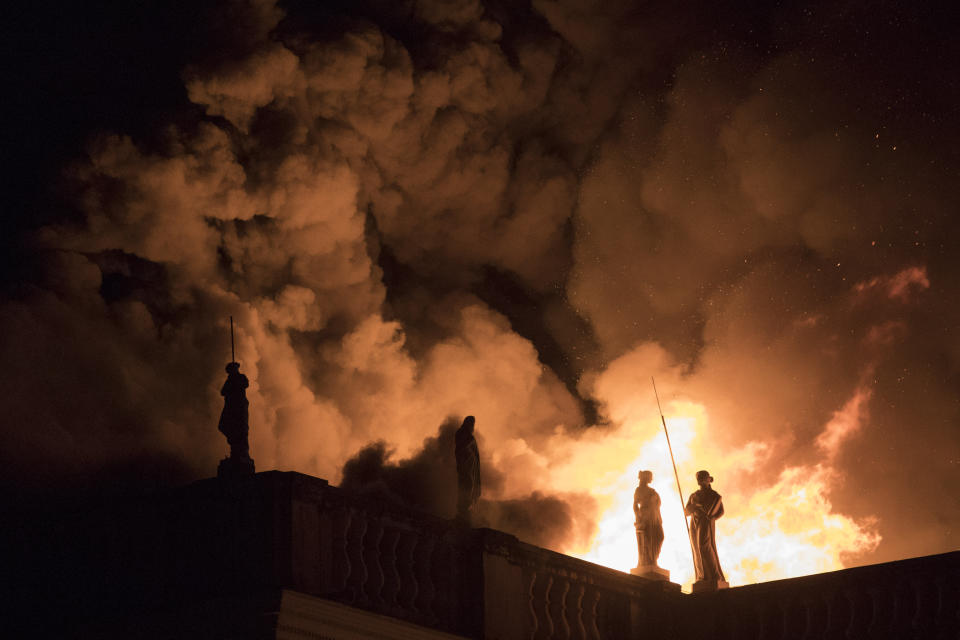 FILE - In this Sept. 2, 2018 file photo, flames engulf the 200-year-old National Museum of Brazil, in Rio de Janeiro. Ever since a fire gutted Brazil's 200-year-old museum, the question has been: Could what was destroyed be restored? (AP Photo/Leo Correa, File)