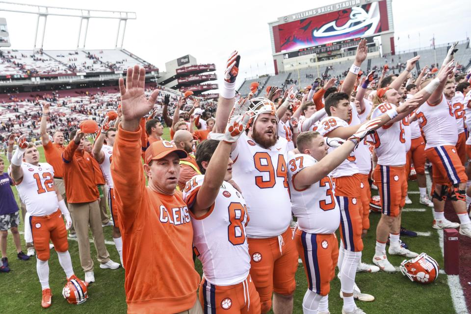 Clemson head coach Dabo Swinney celebrates with players after an NCAA college football game against South Carolina on Nov. 30. (AP)