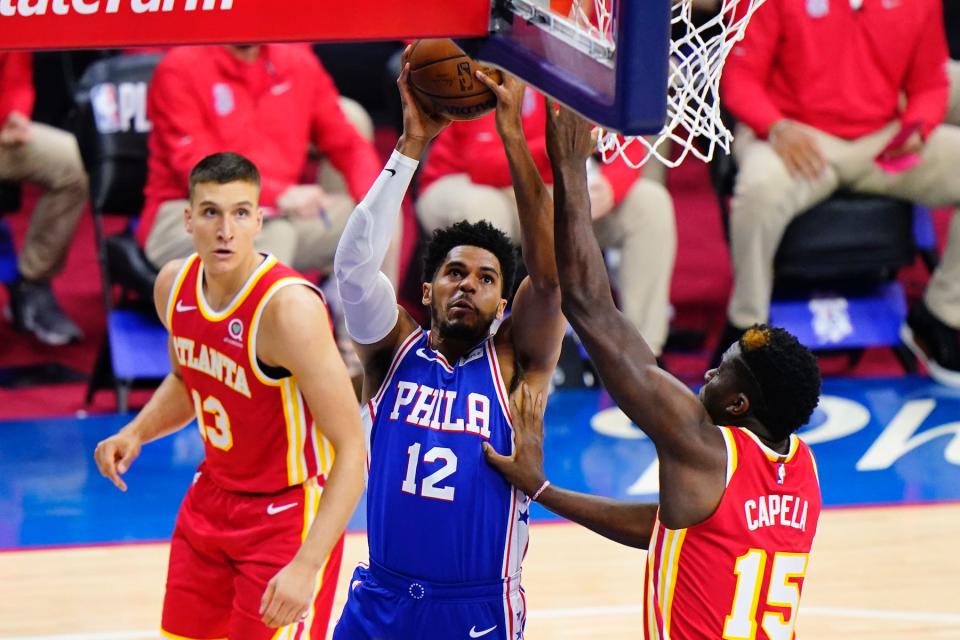 The 76ers' Tobias Harris, center, goes up for a shot against the Hawks' Clint Capela, right, during Game 2 of the second-round playoff series.