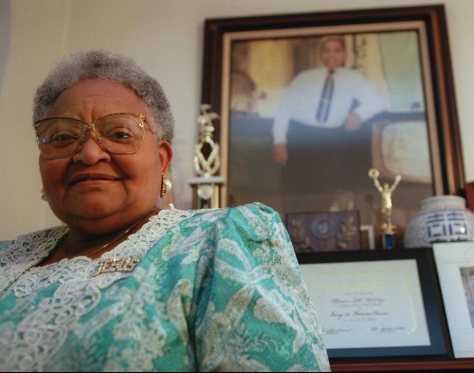 Mamie Till Mobley stands before a portrait of her slain son, Emmett Till, in her Chicago home on July 28, 1995.