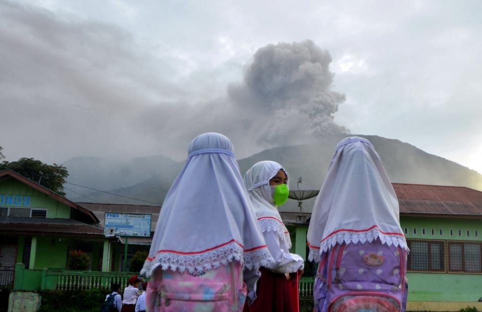 Students are seen at school as Mount Marapi volcano spews volcanic ash as seen from Nagari Batu Palano in Agam, West Sumatra province, Indonesia, December 4, 2023, in this photo taken by Antara Fotovia  