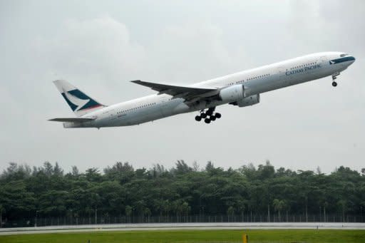 A Cathay Pacific plane takes off from Changi International airport in Singapore. Cathay Pacific Airways posted a first-half net loss of HK$935 million ($121 million), citing higher fuel prices, strong competition and economic instability in Europe