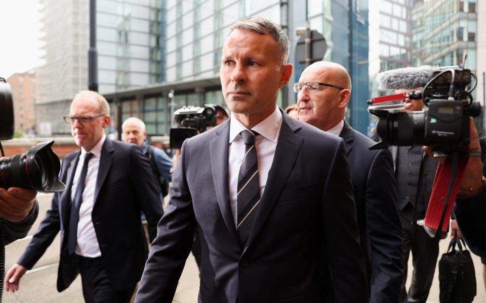 Without emotion, Mr Giggs entered the building - Carl Recine/Reuters