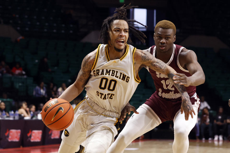 Grambling State guard Virshon Cotton (00) drives to the basket around Texas Southern guard Zytarious Mortle (12) during the first half of an NCAA college basketball game in the championship of the Southwestern Athletic Conference Tournament, Saturday, March 11, 2023, in Birmingham, Ala. (AP Photo/Butch Dill)