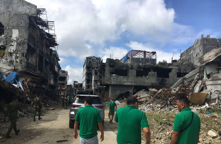 Community leaders survey damaged houses and buildings inside war-torn Marawi, Philippines January 13, 2018. REUTERS/Tom Allard