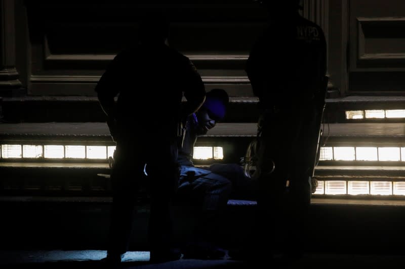 A looter is detained by police officers amid nationwide unrest following the death in Minneapolis police custody of George Floyd, in the Soho district of Manhattan, New York City