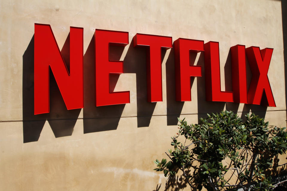 Red Netflix logo on a beige stucco wall.