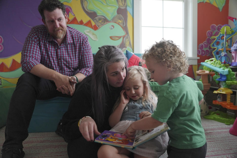 From left, Justin Fell and Katie Czajkowski-Fell spend time with their children, Leonore and Cameron, at home in Bel Air, Md., on Dec. 4, 2023. Czajkowski-Fell, hopes the video evidence of her late son, Hayden, helps finally lead to answers to sudden unexplained death in childhood. “His life, it was too precious and too important for us not to try and do something with this tragedy.” (AP Photo/Shelby Lum)
