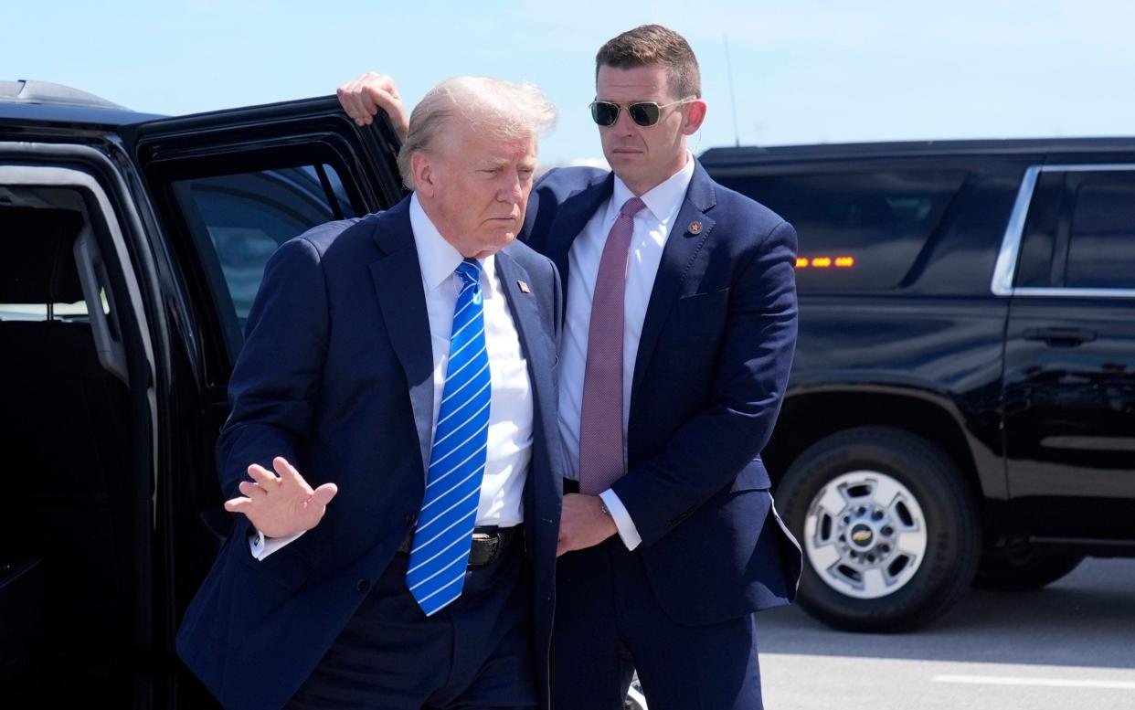 Republican presidential candidate former President Donald Trump waves as he arrives to board his plane at Palm Beach International Airport, Saturday, July 27, 2024, in West Palm Beach, Fla. Trump is headed to Nashville, Tenn., and St. Cloud, Minn. (AP Photo/Alex Brandon)