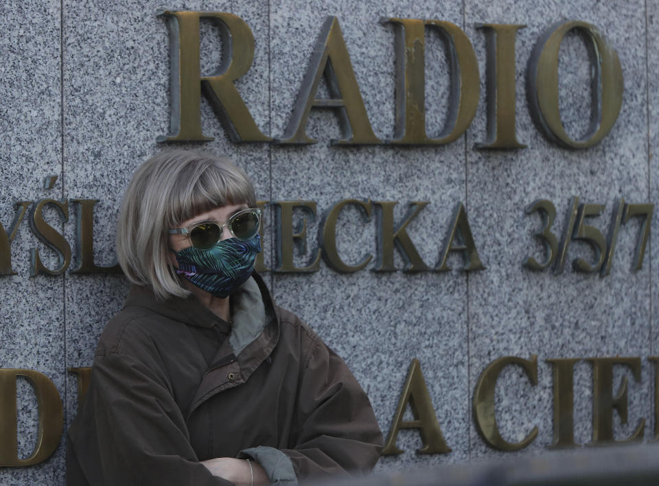 A protester wearing a face mask to protect against coronavirus, attends a protest outside the Polish state-run radio station Radio Trojka, in Warsaw, Poland, Friday, May 22, 2020. The public broadcaster is being accused of censorship after its management removed a hit song that took aim at an alleged abuse of power by Poland's ruling party leader, Jaroslaw Kaczynski. (AP Photo/Czarek Sokolowski)