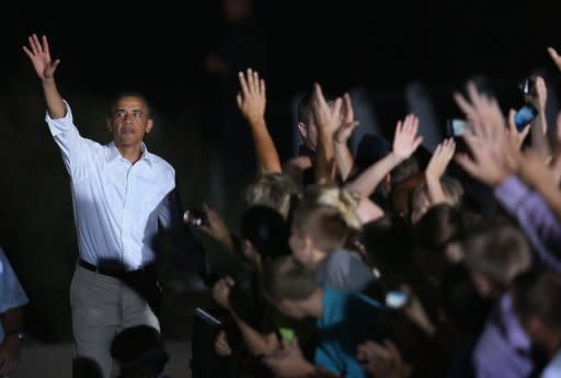 US President Barack Obama leaves a campaign stop at the Waterloo Center for the Arts August 14, 2012 in Iowa. The stop was part of a three-day, nine-city campaign trip across Iowa. Obama thrust home his claim that Romney, a former multi-millionaire venture capitalist would further enrich his wealthy friends with tax cuts