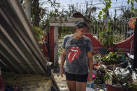 Jessika Dorantes stands in the home of her mother Estela Sandoval after it was destroyed by Hurricane Otis, as she helps to clean up, in Acapulco, Mexico, Friday, Oct. 27, 2023. Sandoval was among hundreds of thousands of people whose lives were torn apart when the fastest intensifying hurricane on record in the Eastern Pacific shredded the coastal city of 1 million. (AP Photo/Felix Marquez)