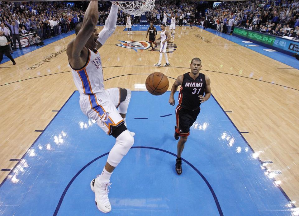 Oklahoma City Thunder guard Russell Westbrook (0), who missed the previous 27 games after having a surgery on his right knee, dunks in front of Miami Heat forward Shane Battier (31) for his first basket of the game in the first quarter of an NBA basketball game in Oklahoma City, Thursday, Feb. 20, 2014. Miami won 103-81. (AP Photo/Sue Ogrocki)