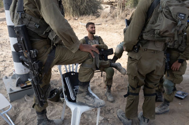 Israeli soldiers relax at a staging area in southern Israel close to the Gaza Strip border on Tuesday ahead of a possible ground invasion. Photo by Jim Hollander/UPI