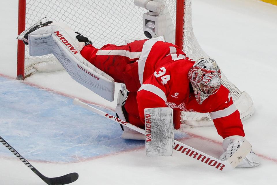 Detroit Red Wings goaltender Alex Lyon (34) dives to make a save against Buffalo Sabres during the first period at Little Caesars Arena in Detroit on Sunday, April 7, 2024.