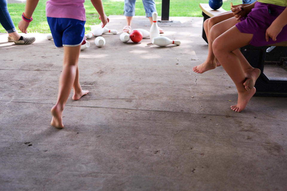 Image: Erin McAlvany's family plays at a meal site in Kirksville, Mo., on  Aug. 16, 2022. (Arin Yoon for NBC News)
