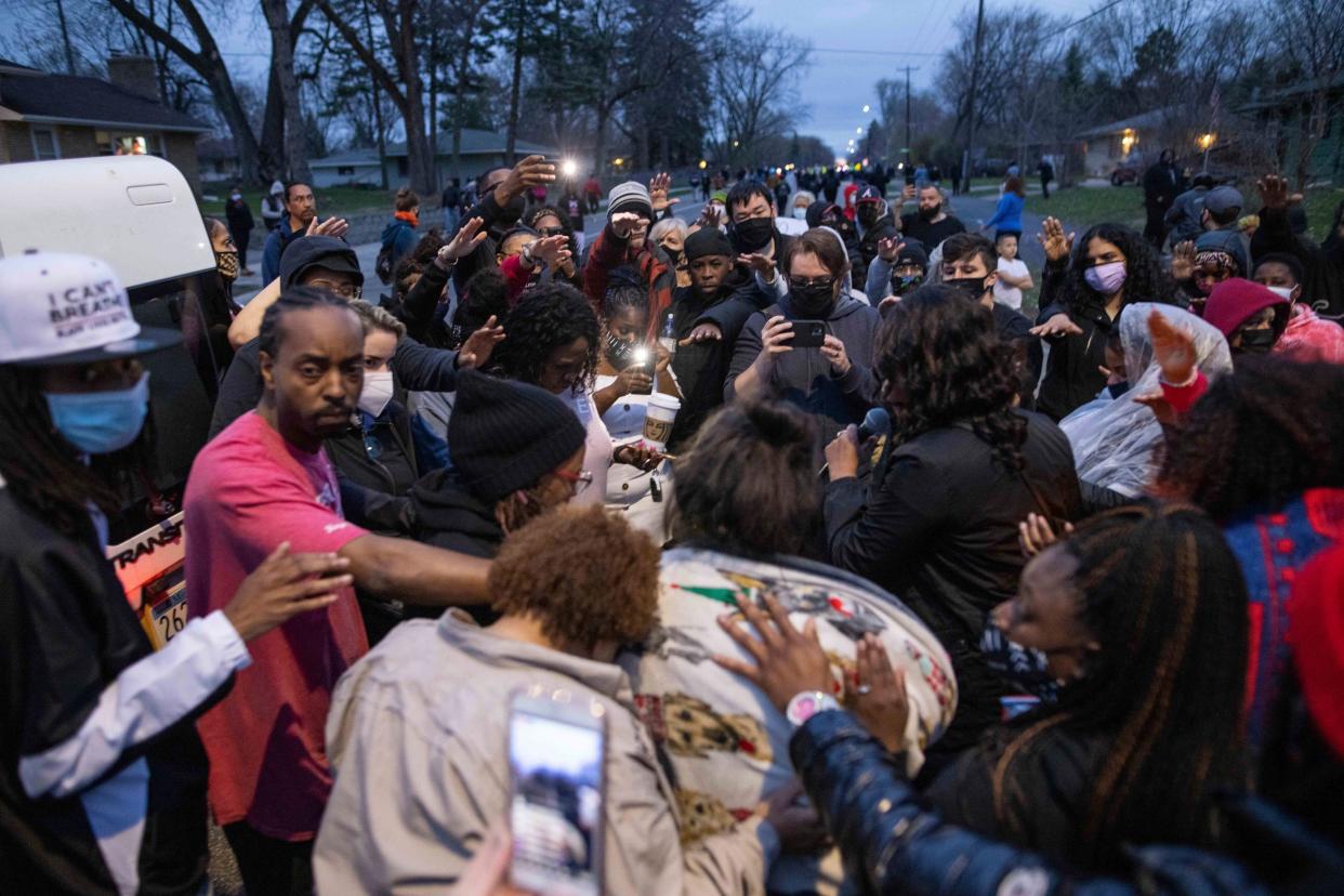 Family and friends, foreground, of Daunte Wright, 20, mourn Sunday, April 11, 2021, in Brooklyn Center, Minnesota.