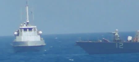 An Iranian vessel steers close to the U.S. Navy coastal patrol craft USS Thunderbolt (R) in the Gulf in a still image from video provided by the U.S. Navy July 25, 2017. U.S. Navy/Handout via REUTERS