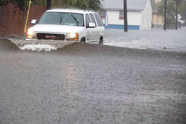 PHOTO: In this Sept. 22, 2020, file photo, a vehicle drives through floodwaters from Tropical Storm Beta, in Galveston, Texas. (Brett Coomer/AP, FILE)