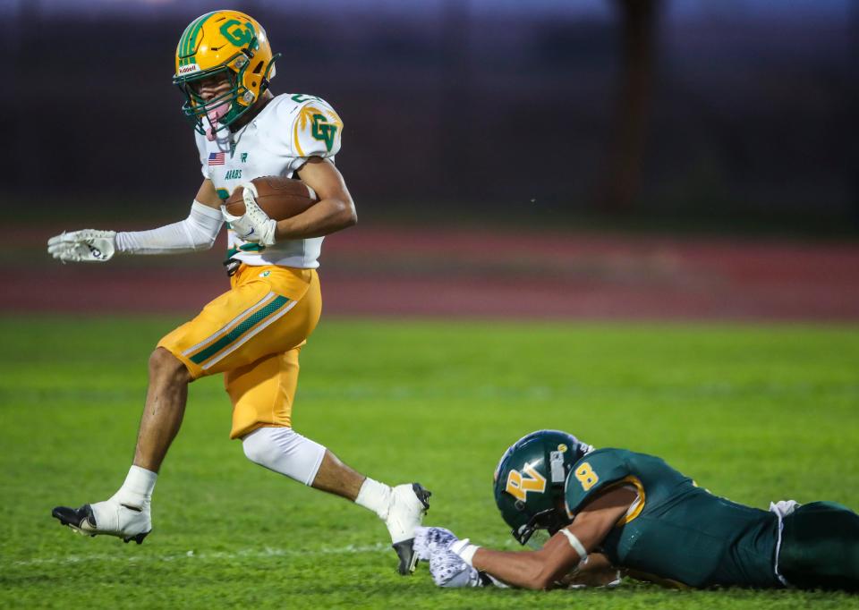 Coachella Valley's Aaron Ramirez (23) avoids a near-shoestring tackle by Palo Verde's Gabriel De Leon (8) on his way to the end zone during the first quarter of their game at Palo Verde High School in Blythe, Calif., Friday, Aug. 25, 2023.