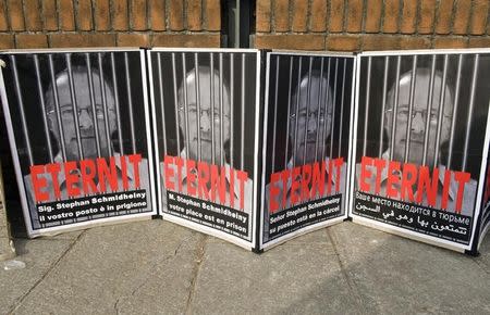 Posters reading "Stephan Schmidheiny your place is in prison" are displayed outside the courthouse during a trial against the Swiss firm Eternit's Italian plant in Turin February 13, 2012. REUTERS/Giorgio Perottino