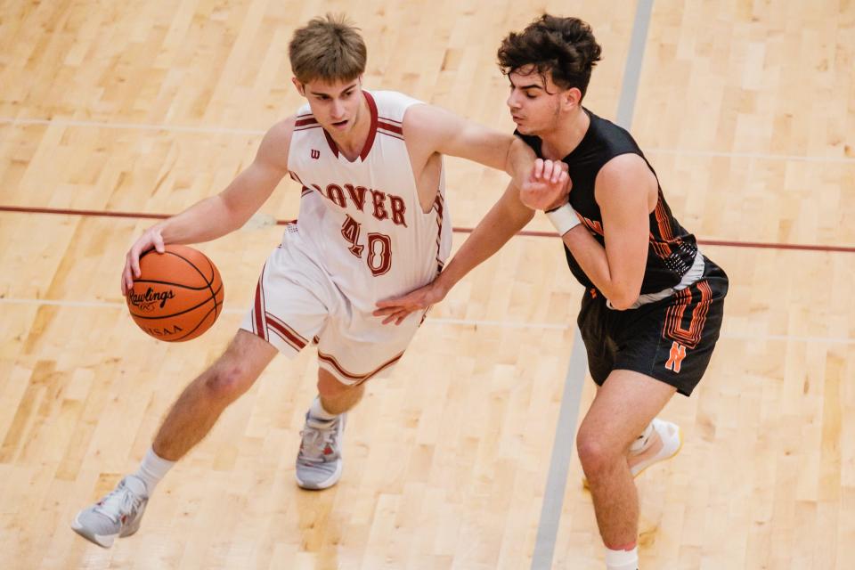 Dover's Ayden Hall drives around Normandy's Nadir Ibrahim this past season.