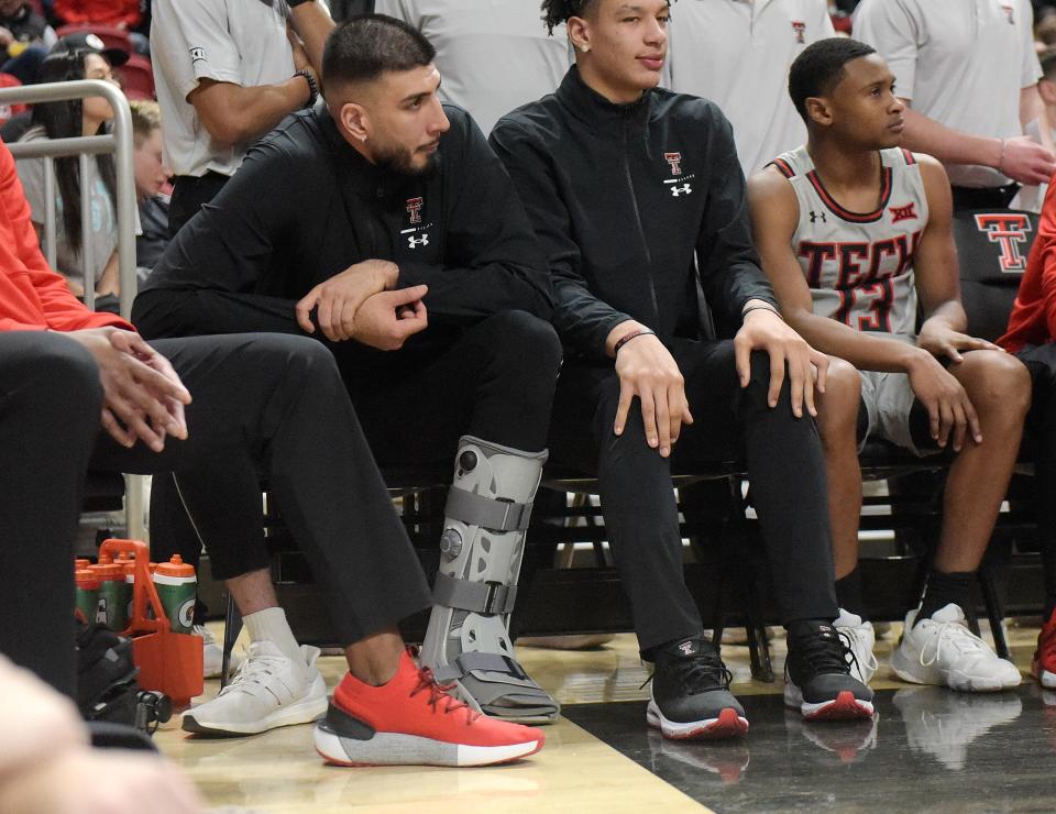 Texas Tech's forward Fardaws Aimaq (11), left, wears a boot during the West Virginia basketball game, Wednesday, Jan. 25, 2023, at United Supermarkets Arena. 