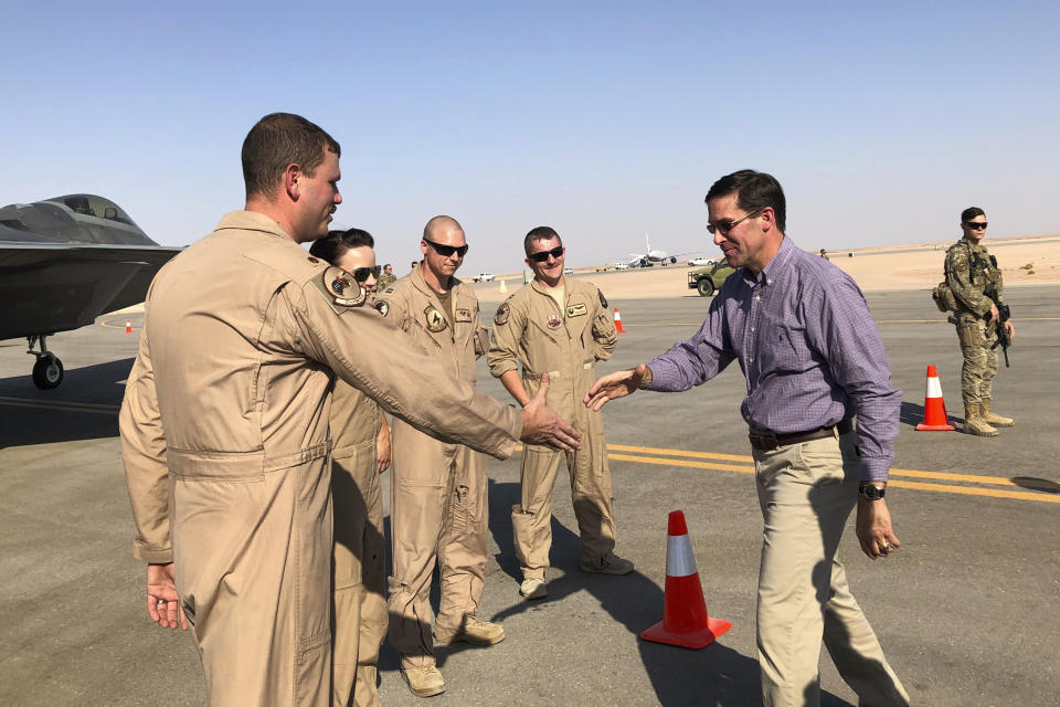 Defense Secretary Mark Esper talks with U.S. troops in front of an F-22 fighter jet deployed to Prince Sultan Air Base in Saudi Arabia, Tuesday, Oct. 22, 2019. (AP Photo/Lolita Baldor)