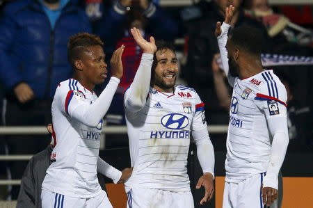 Olympique Lyon's Clinton N'Jie (L) reacts with teammates after scoring against Saint-Etienne during their French Ligue 1 soccer match at the Gerland stadium in Lyon April 19, 2015. REUTERS/Robert Pratta