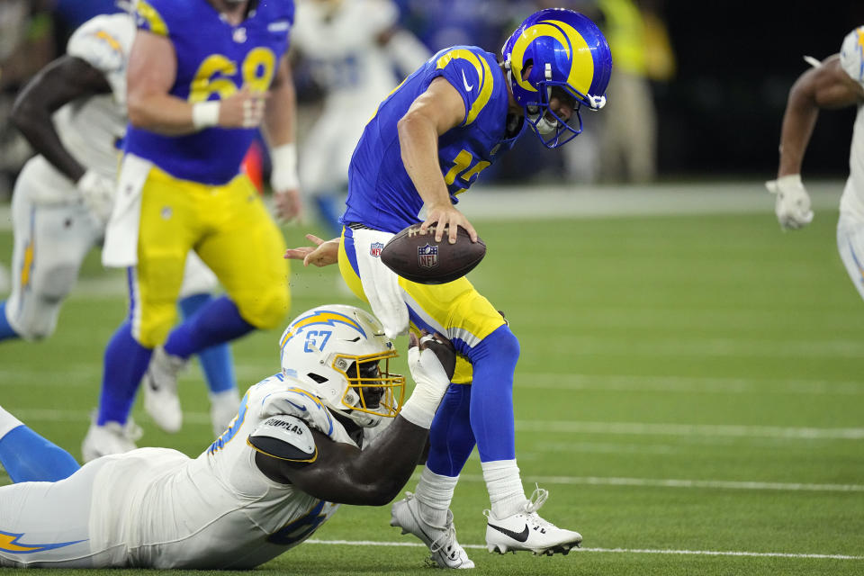 Los Angeles Rams quarterback Stetson Bennett, top, is sacked by Los Angeles Chargers defensive tackle CJ Okoye during the second half of a preseason NFL football game Saturday, Aug. 12, 2023, in Inglewood, Calif. (AP Photo/Mark J. Terrill)