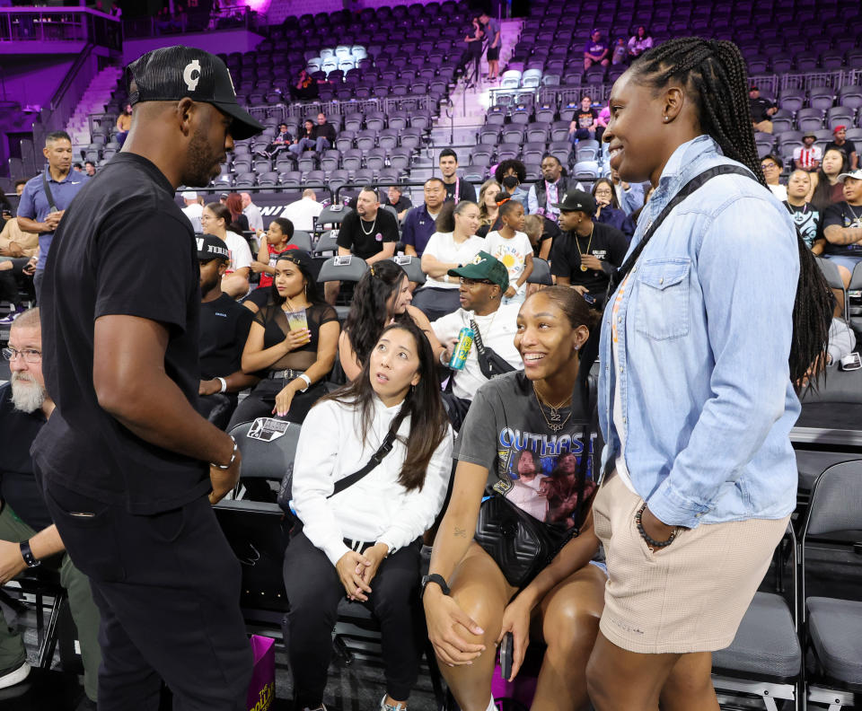 Phoenix Suns point guard Chris Paul, Las Vegas Aces assistant coach Natalie Nakase, Aces forward A&#39;ja Wilson and point guard Chelsea Gray chat on the sideline of an exhibition game between Boulogne-Levallois Metropolitans 92 and G League Ignite at The Dollar Loan Center in Henderson, Nevada, on Oct. 4, 2022. (Ethan Miller/Getty Images)
