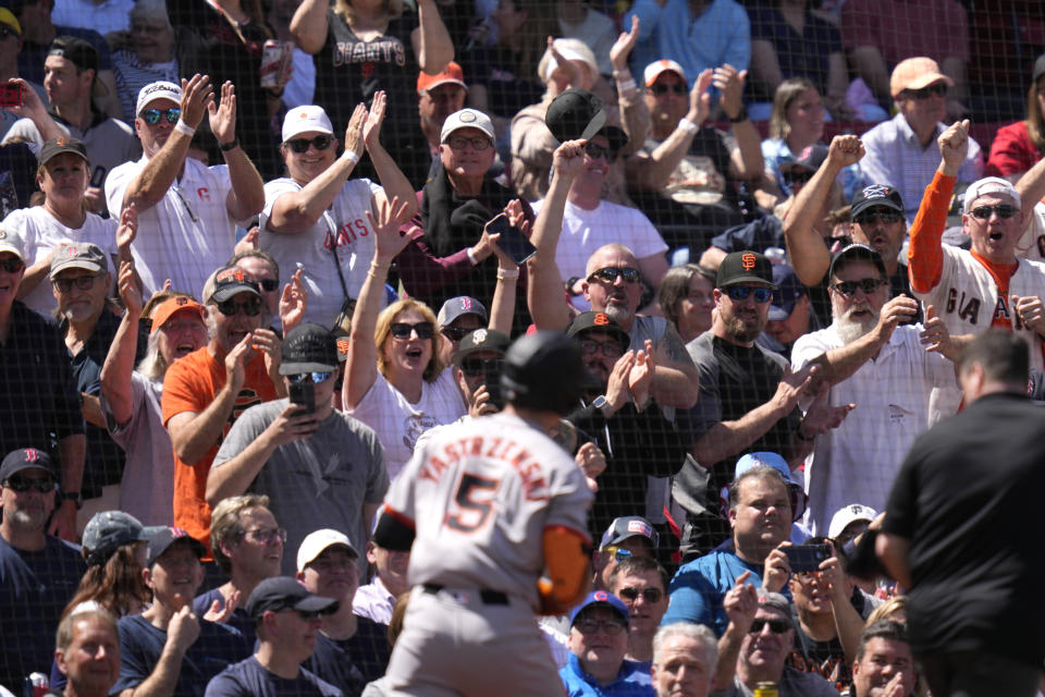 San Francisco Giants fans cheer after a solo home run by Mike Yastrzemski (5) during the third inning of a baseball game against the Boston Red Sox at Fenway Park, Thursday, May 2, 2024, in Boston. (AP Photo/Charles Krupa)