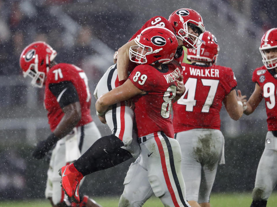 Georgia place kicker Rodrigo Blankenship (98) celebrates with Charlie Woerner (89) after kicking a 49-yard field goal in the first half of an NCAA college football game against Texas A&M, Saturday, Nov. 23, 2019, in Athens, Ga. (AP Photo/John Bazemore)