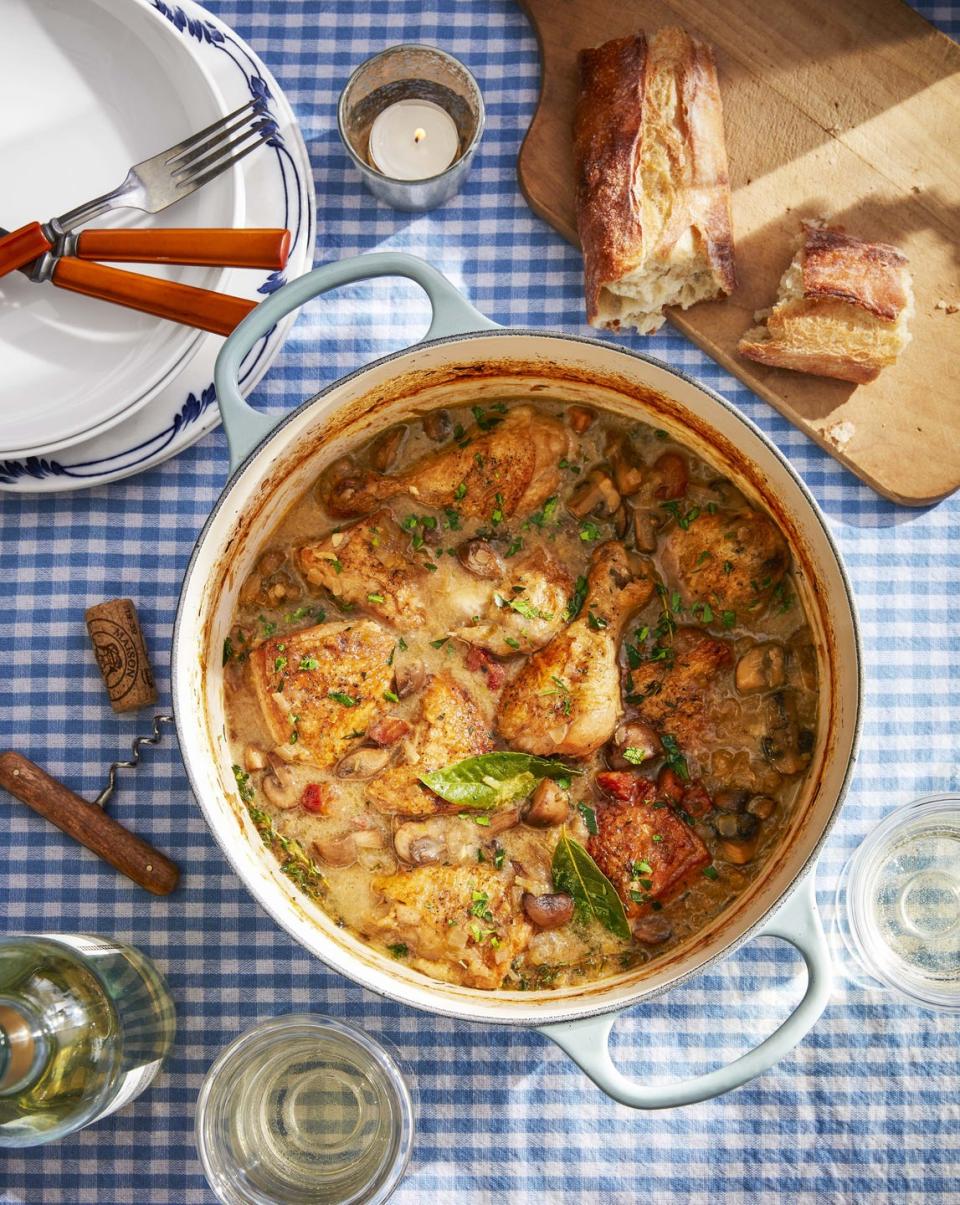 white wine coq au vin in an enamel cast iron dutch oven