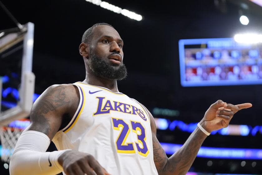 Los Angeles Lakers forward LeBron James gestures after scoring during the first half.