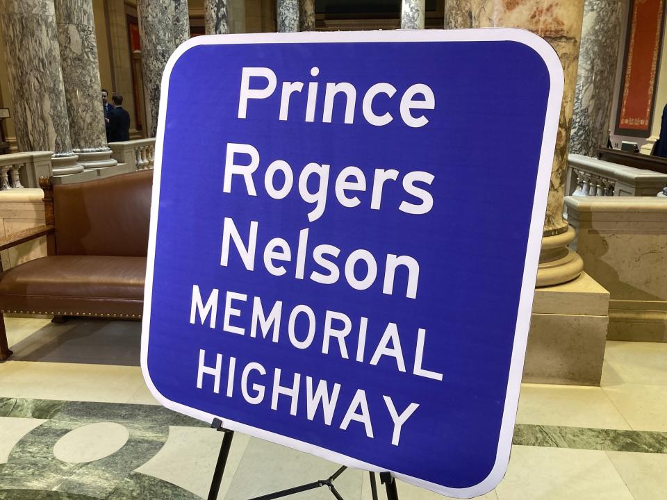 A replica sign stands outside the Minnesota Senate chambers, Thursday, May 4, 2023, in St. Paul, Minn., after the Senate voted to honor the late pop superstar Prince by designating the highway that runs past his Paisley Park museum and studios in Chanhassen, Minn., as the Prince Rogers Nelson Memorial Highway. The signs are expected to go up soon. (AP Photo/Steve Karnowski)