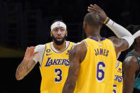 Los Angeles Lakers forward Anthony Davis, left, is congratulated by forward LeBron James after scoring during the second half of an NBA basketball game against the Portland Trail Blazers Wednesday, Nov. 30, 2022, in Los Angeles. (AP Photo/Mark J. Terrill)