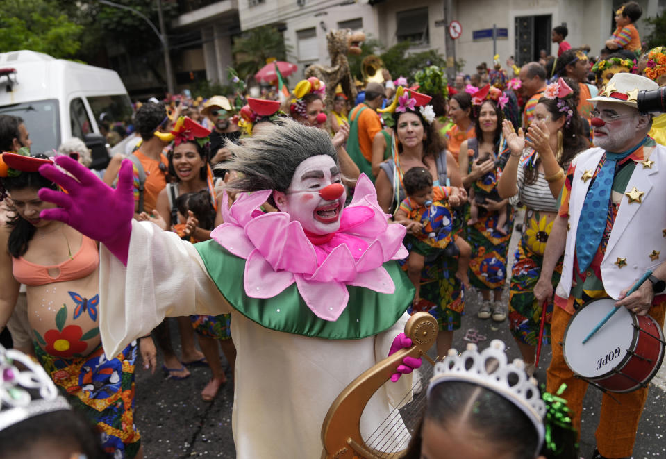 Revelers participate in the "Gigantes da Lira" street block party in Rio de Janeiro, Brazil, Sunday, Feb. 12, 2023. Merrymakers are taking to the streets for the open-air block parties, leading up to Carnival's official Feb. 17th opening. (AP Photo/Silvia Izquierdo)