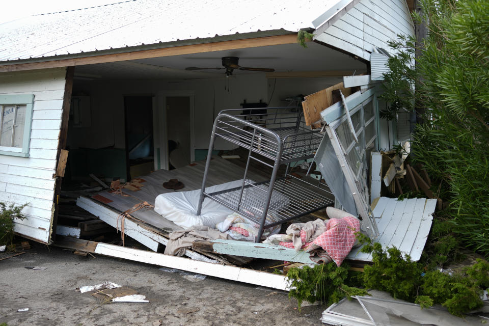 Bunk beds lean inside a home that was swept from its lot and broken open in Horseshoe Beach, Fla., Thursday, Aug. 31, 2023, one day after the passage of Hurricane Idalia. (AP Photo/Rebecca Blackwell)