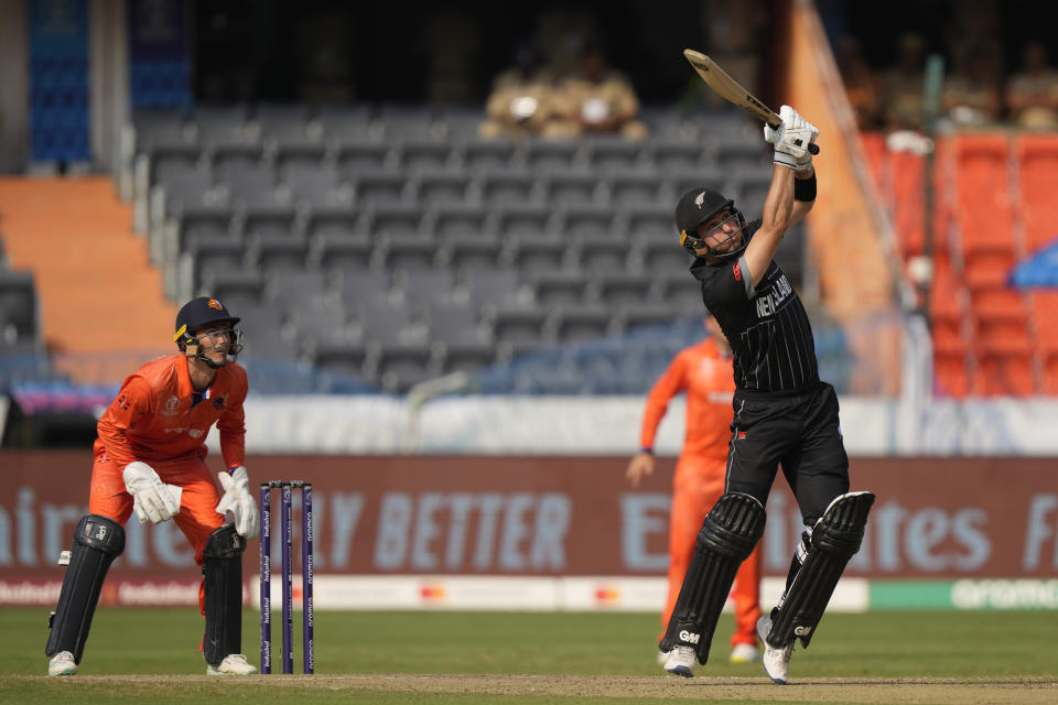 Netherlands' wicketkeeper Netherlands' captain Scott Edwards, left, watches as New Zealand's Will Young plays a shot during the ICC Men's Cricket World Cup match between New Zealand and Netherlands in Hyderabad, India, Monday, Oct. 9, 2023. (AP Photo/Mahesh Kumar A.)