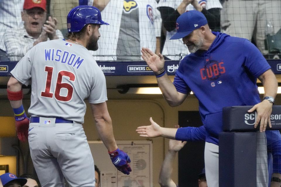 Chicago Cubs' Patrick Wisdom is congratulated by manager David Ross after hitting a home run during the first inning of a baseball game against the Milwaukee Brewers Saturday, Sept. 30, 2023, in Milwaukee. (AP Photo/Morry Gash)