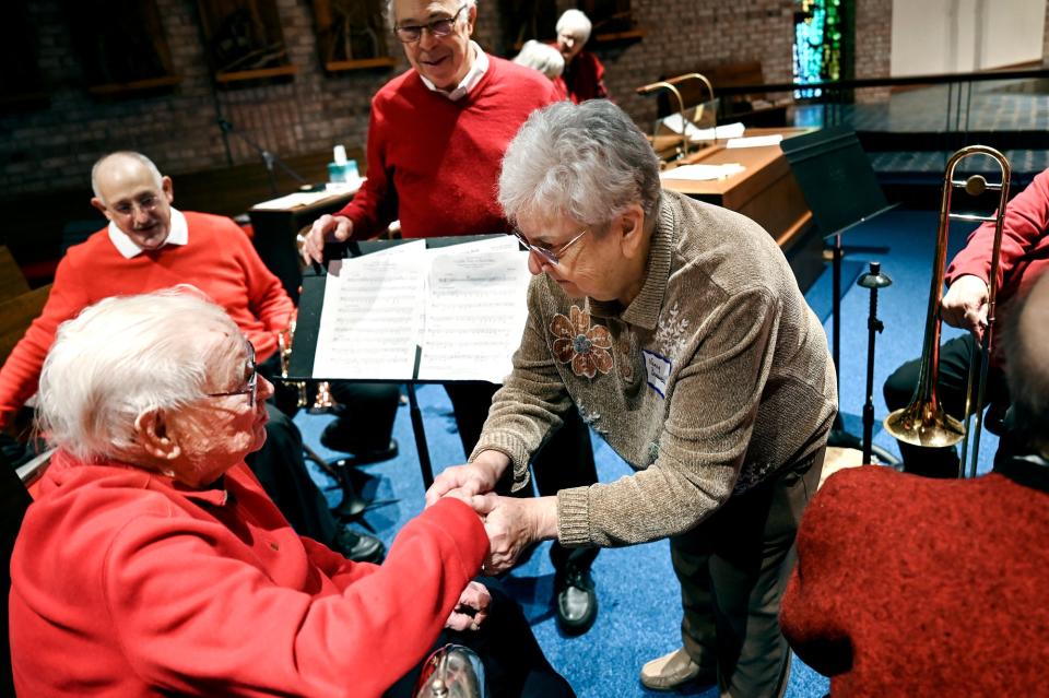 Nancy Brousseau, right, meets with tuba player Henry Nelson, 100, his performance with the Asbury Brass Quintet on Wednesday, Dec. 7, 2022, at Ascension Lutheran Church in East Lansing. Nelson started playing tuba decades ago, stopped for a while and picked it back up for the past 20 years. He has been playing the flute and piccolo for more than 80 years.
