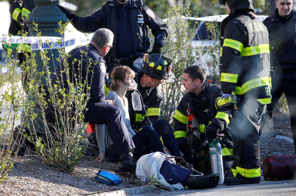 First responders assist a woman&nbsp;injured on the bike path.