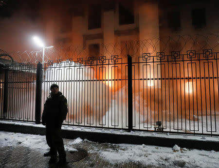 Smoke from a flare thrown by a protester is seen during a rally against the seizure by Russian special forces of three of the Ukrainian navy ships, which Russia blocked from passing through the Kerch Strait into the Sea of Azov in the Black Sea, in front of the Russian embassy in Kiev, Ukraine November 25, 2018. REUTERS/Gleb Garanich