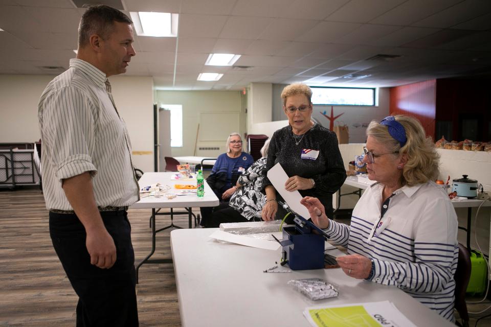 Poll workers check in a voter inside of the Ross County Library Annex before he casts his vote for the Ohio election on November 8, 2023, in Chillicothe, Ohio,
