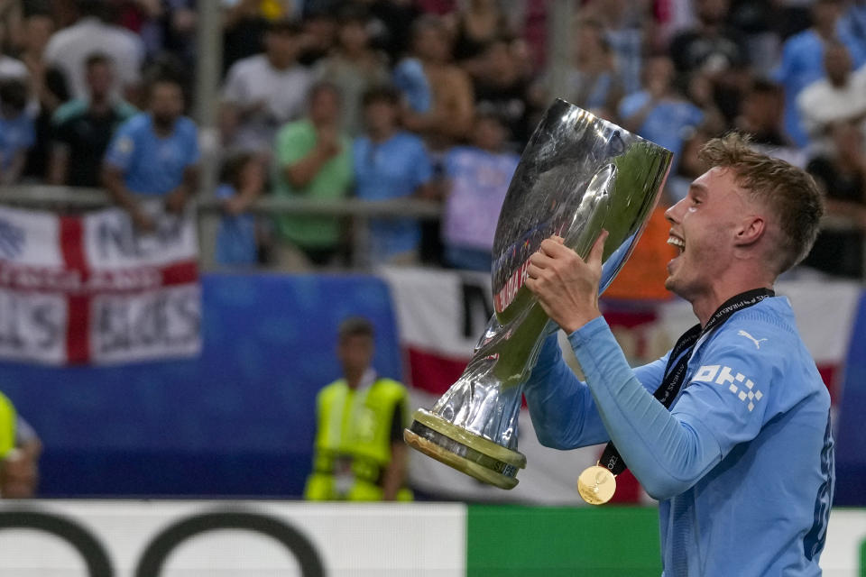 Manchester City's Cole Palmer celebrates with trophy after winning the UEFA Super Cup Final soccer match between Manchester City and Sevilla at Georgios Karaiskakis stadium in Piraeus port, near Athens, Greece, Wednesday, Aug. 16, 2023. (AP Photo/Thanassis Stavrakis)