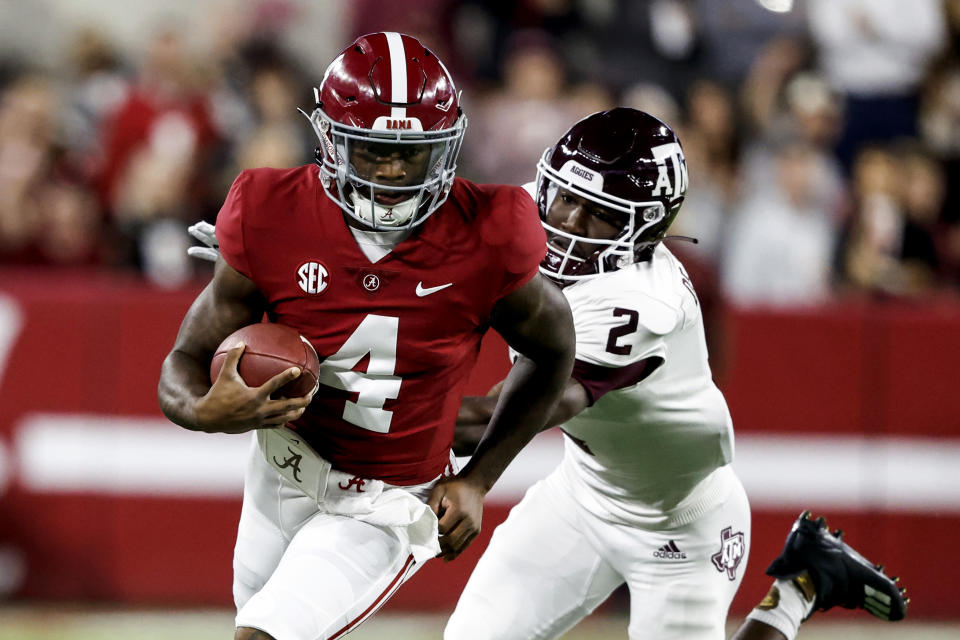 Oct 8, 2022; Tuscaloosa, Alabama; Alabama Crimson Tide quarterback Jalen Milroe (4) scrambles for yardage against Texas A&M Aggies defensive back Denver Harris (2) during the first half at Bryant-Denny Stadium. Butch Dill-USA TODAY Sports