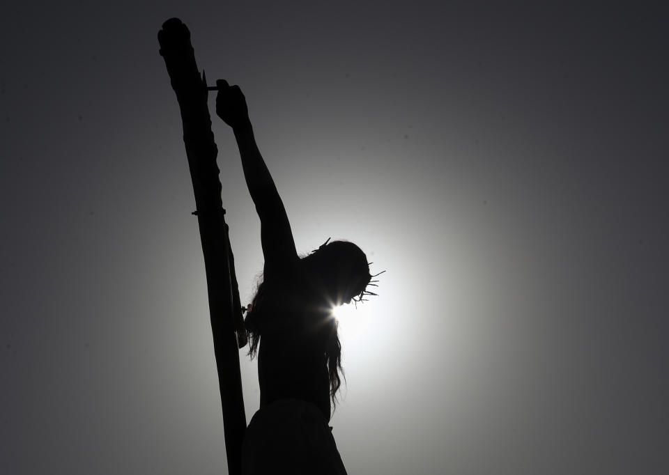 A Christian enacts the crucifixion of Jesus Christ to mark Good Friday in Hyderabad, India, Friday, April 2, 2021. Christians all over the world attend mock crucifixions and passion plays that mark the day Jesus was crucified, known to Christians as Good Friday. (AP Photo/Mahesh Kumar A.)