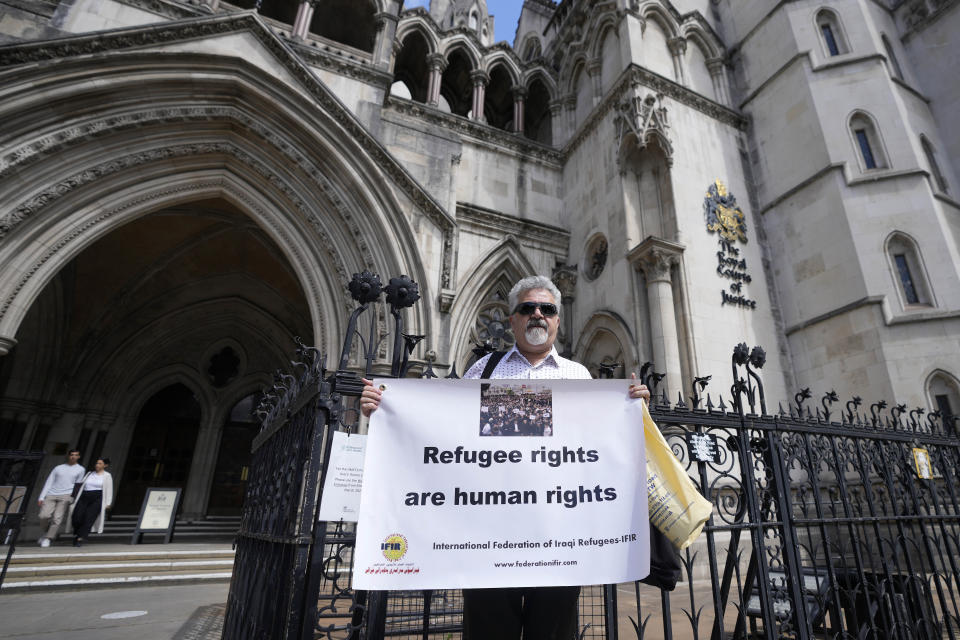 Protestors stand outside The Royal Court of Justice in London, Friday, June 10, 2022. The High Court will hear a legal challenge lodged by Care4Calais, the Public and Commercial Services Union (PCS) and Detention Action, opposing the Home Office's new asylum deal with Rwanda. The case alleges that Priti Patel's proposals are in contravention of international law and the UN refugee convention. (AP Photo/Frank Augstein)